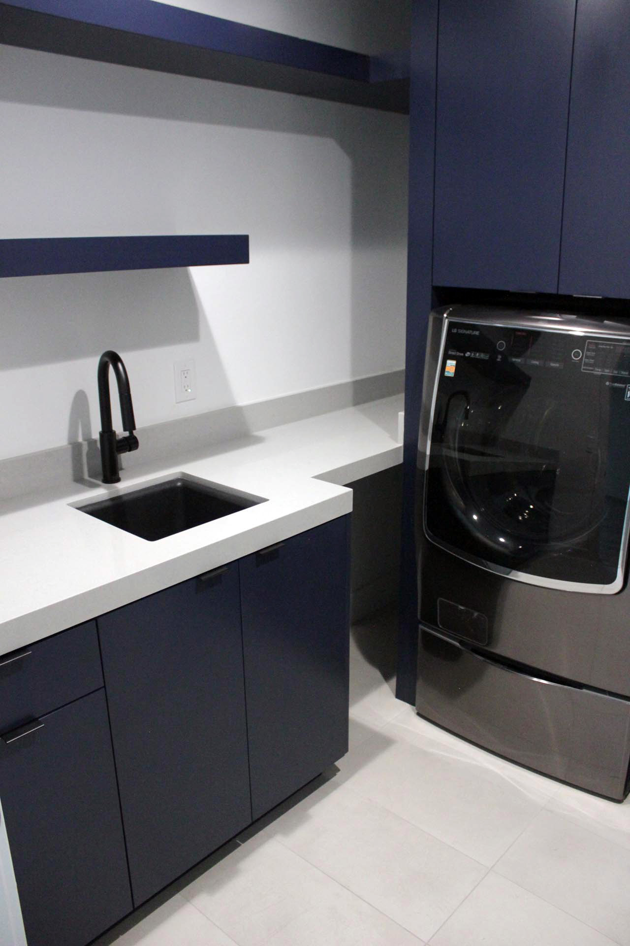 Laundry room modern blue cabinet with white stone top