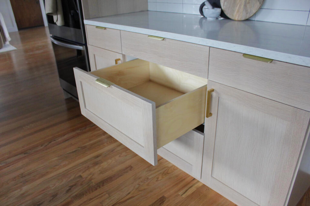 White wood kitchen cabinet shaker with gold accessories