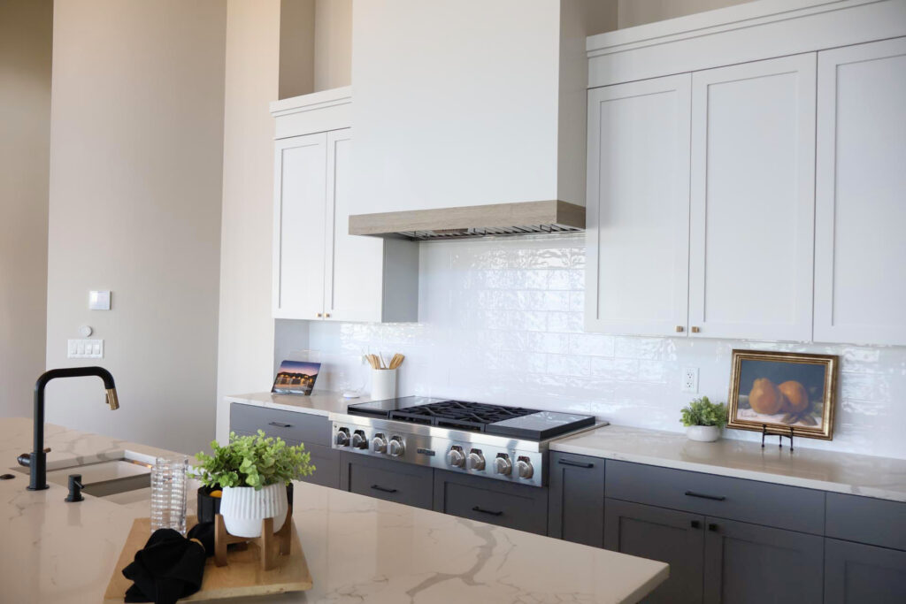 Kitchen shakers and wall cabinets next to an island