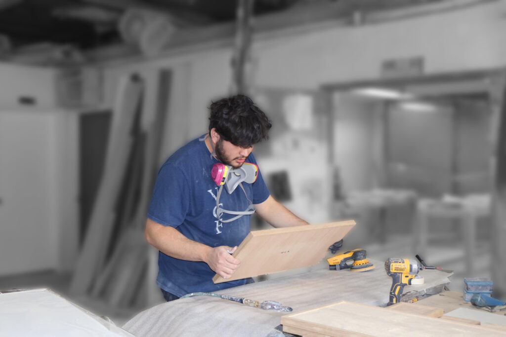 Painter sanding cabinet doors